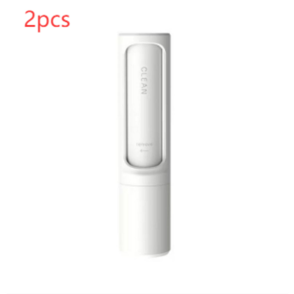 Two white self-cleaning pet hair remover brushes designed for removing pet fur, lint, and fluff from clothing, furniture, and bedding.