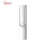 Two white self-cleaning pet hair remover brushes designed for removing pet fur, lint, and fluff from clothing, furniture, and bedding.
