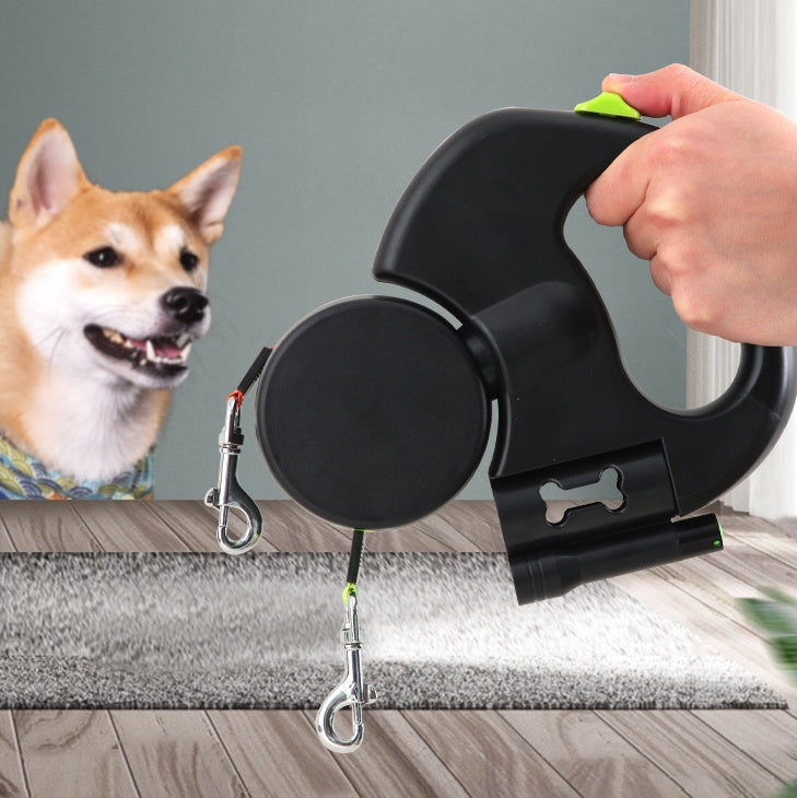 Person holding a dual retractable dog leash next to a dog on a wooden floor, showcasing comfortable handling and convenient control for everyday walks.