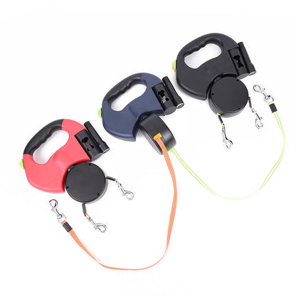 Four dual retractable dog leashes in different colors displayed on a white background, featuring LED lighting and a 360-degree tangle-free design for walking two dogs.