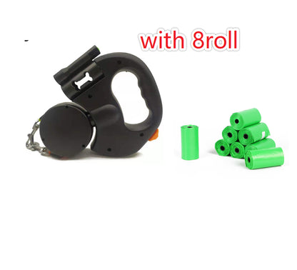 Black dual retractable dog leash with eight green waste bag refill rolls on a white background, designed for convenient and hassle-free dog walking.