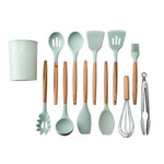 Set of kitchen utensils with green handles and wooden handles on a white background