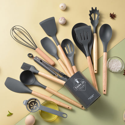 Set of kitchen utensils including spatulas, ladles, and a whisk on a light background.