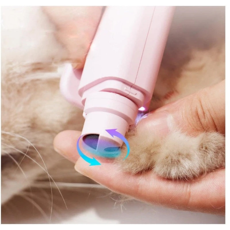Person using a pink LED pet nail trimmer on a cat's paw, demonstrating safe and comfortable nail grooming at home.