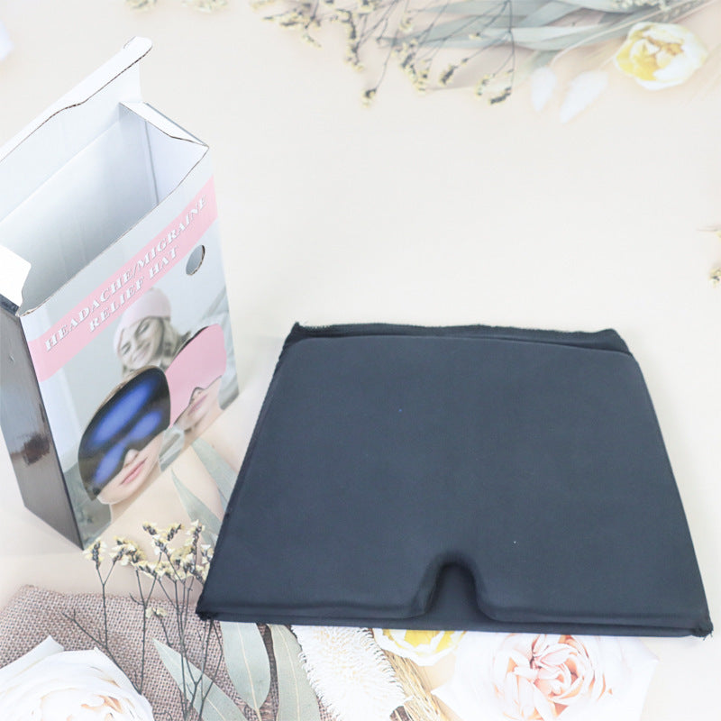 Black fabric square with a box featuring eye masks on a decorative background