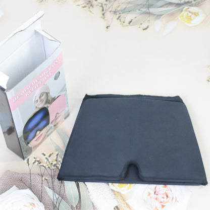 Black fabric square with a box featuring eye masks on a decorative background
