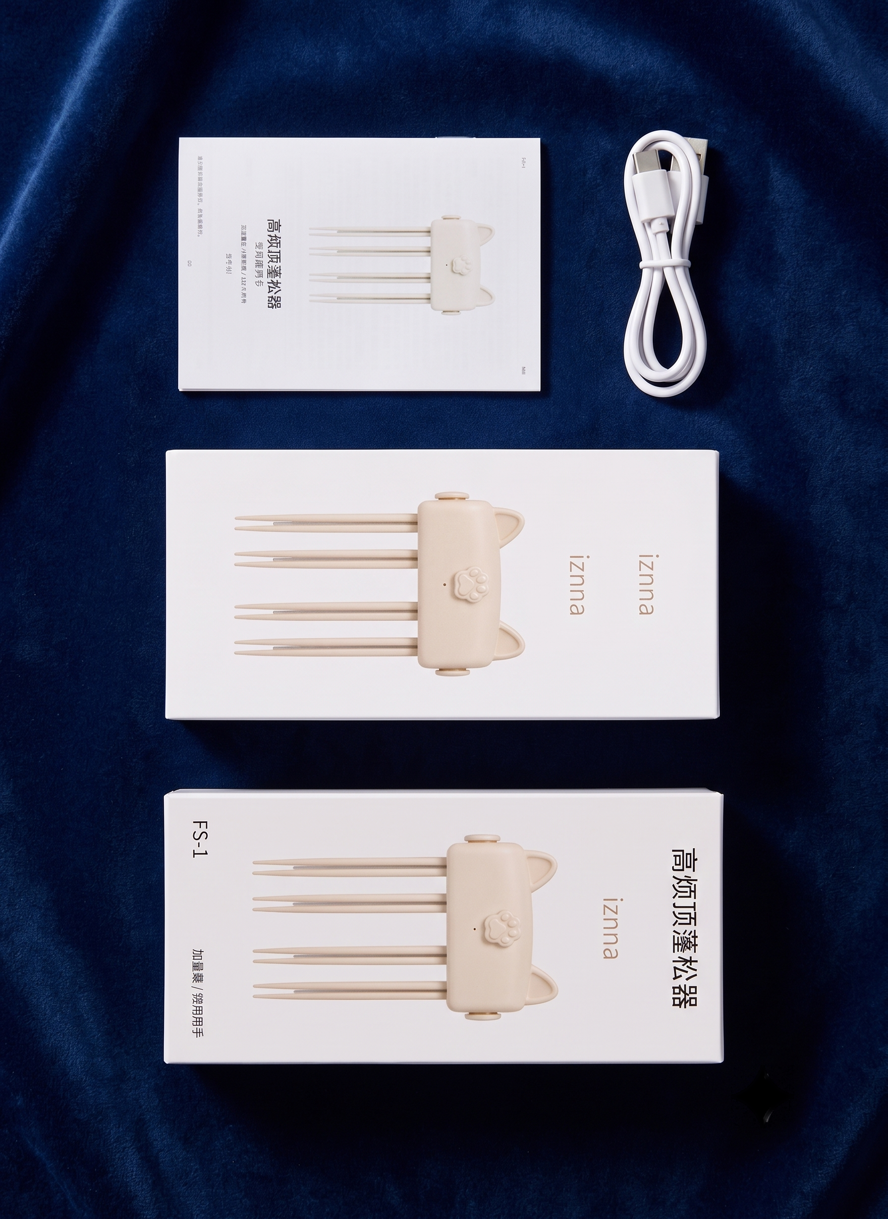 Three white product boxes for a set of four hair extension attachment needles, a white USB charging cable, and a small instruction card, arranged vertically on a dark blue velvet fabric background. The brand name 'Zenna' is visible on the packaging.