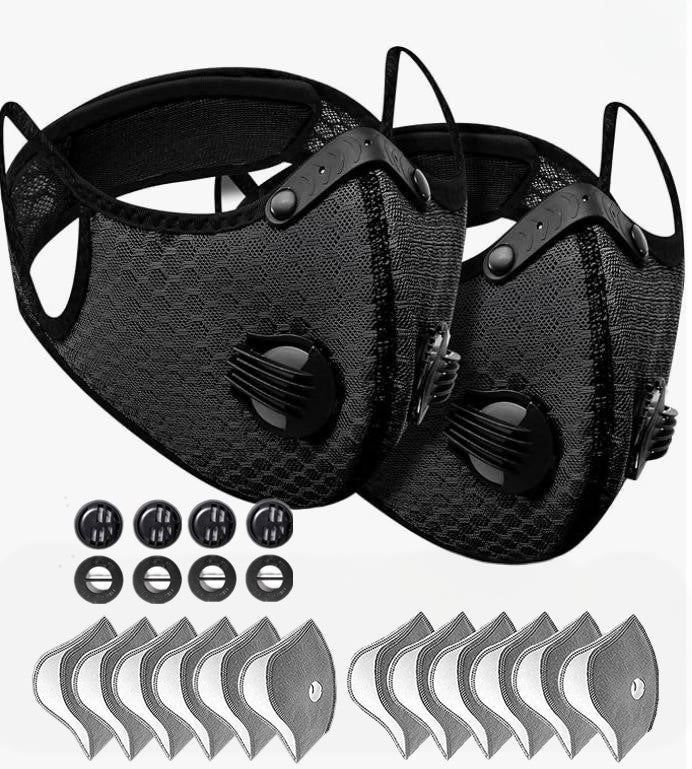 Two black face masks with filter cartridges on a white background