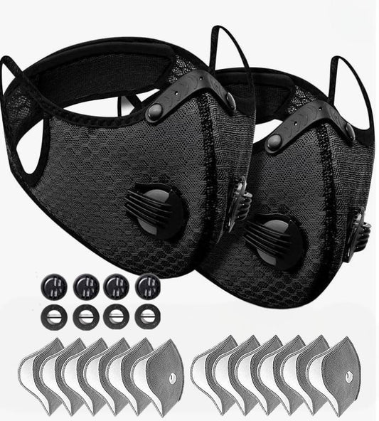 Two black face masks with filter cartridges on a white background