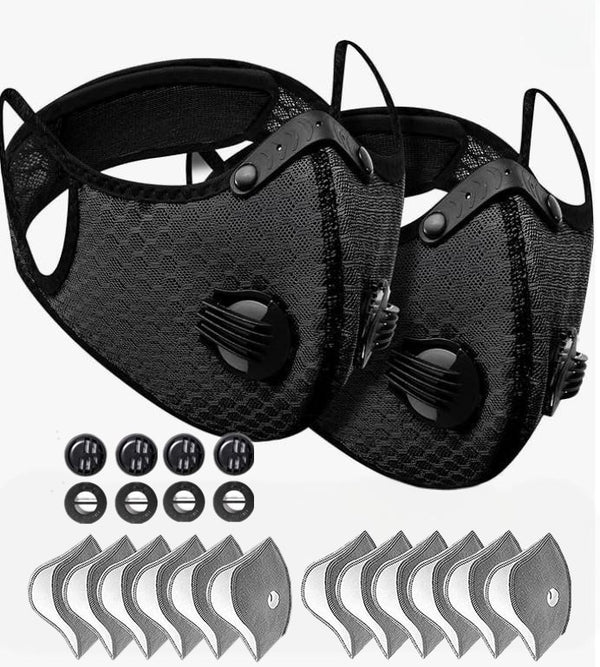 Two black face masks with filter cartridges on a white background
