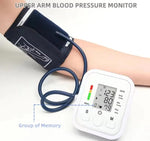 Upper arm blood pressure monitor with digital display on a white background