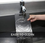 Person washing a clear plastic card under running water from a faucet with 'EASY TO CLEAN' text displayed.